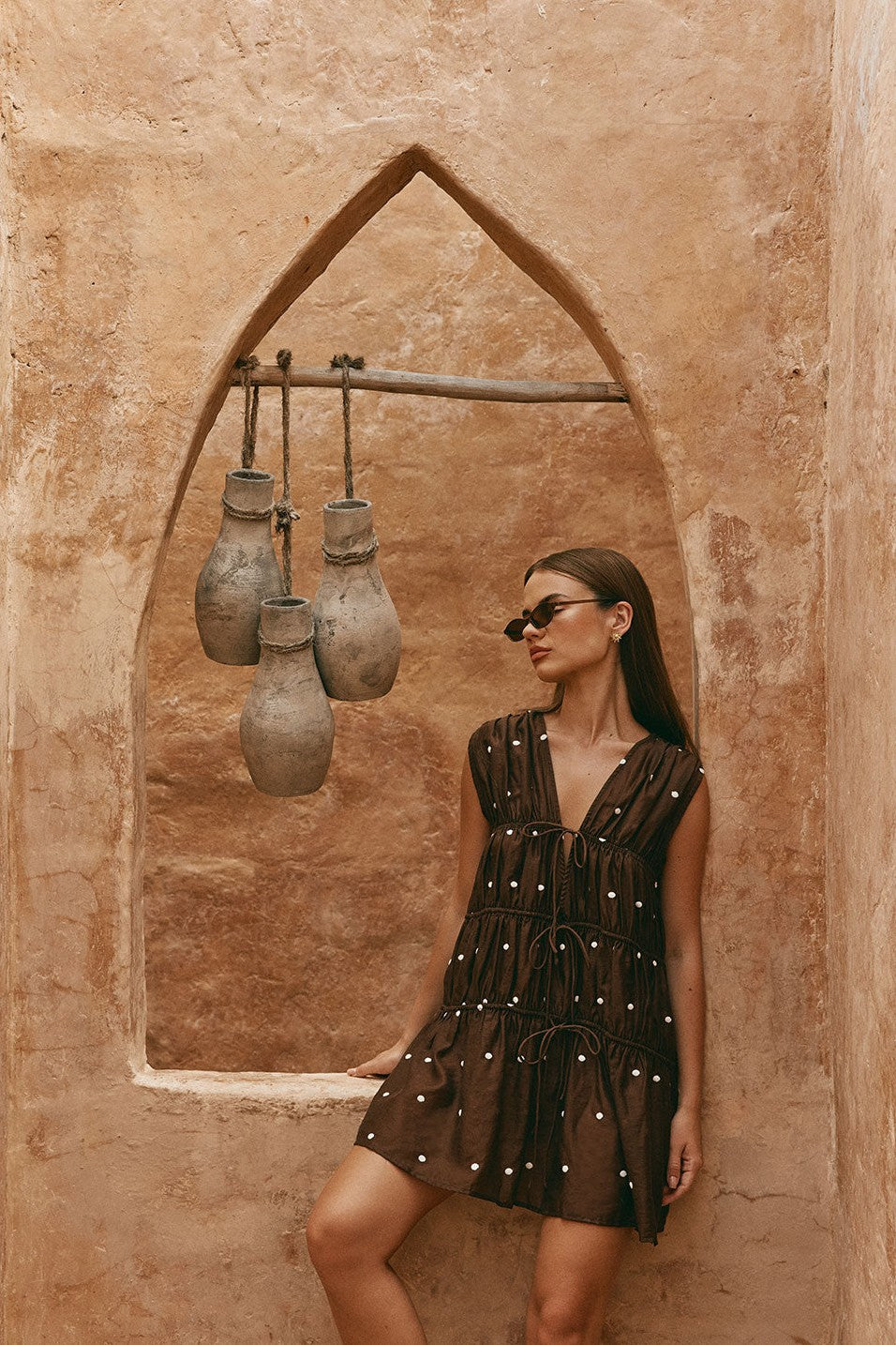 Brown mini dress with a V neckline, back view