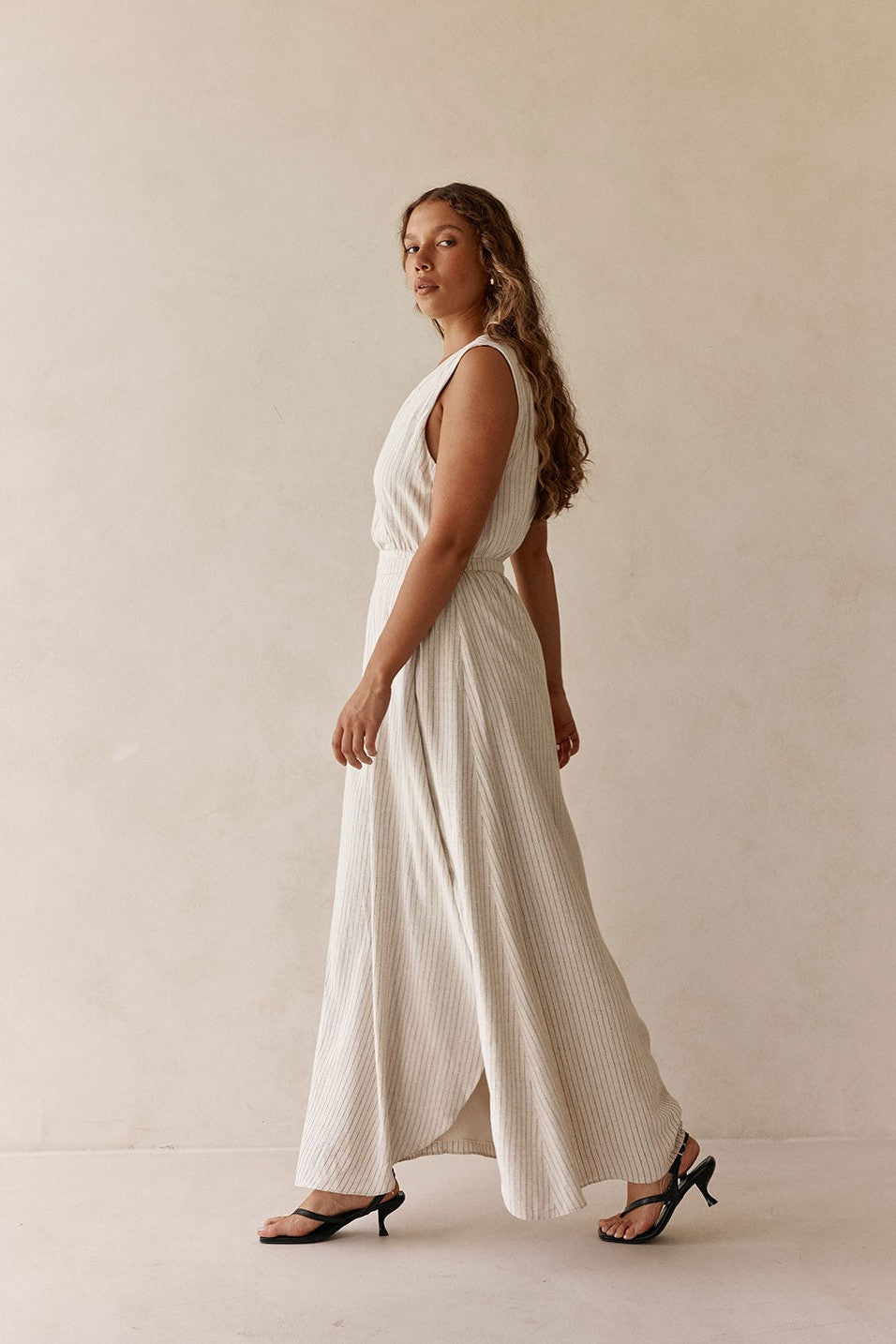 Beige maxi dress with a wrap silhouette, styled on model