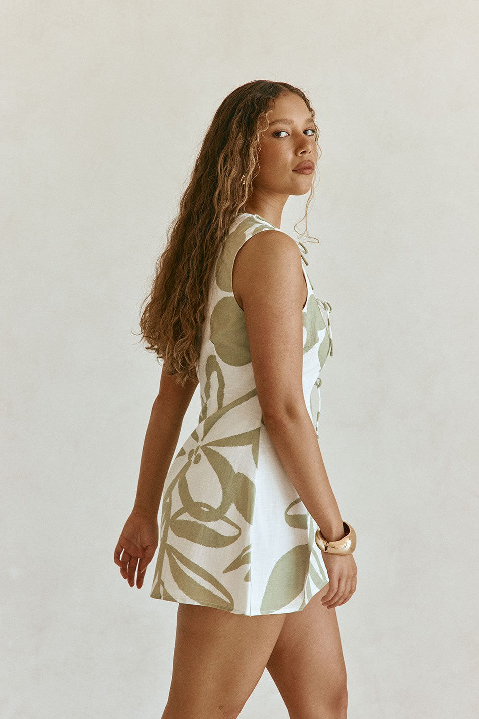 Green mini dress with a round neckline, styled on model