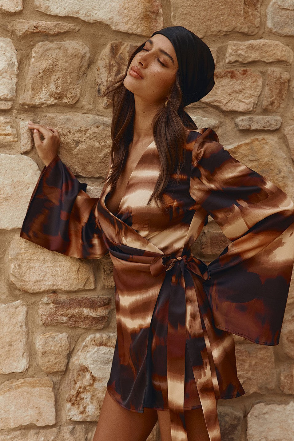 Brown mini dress with a wrap silhouette, styled on model