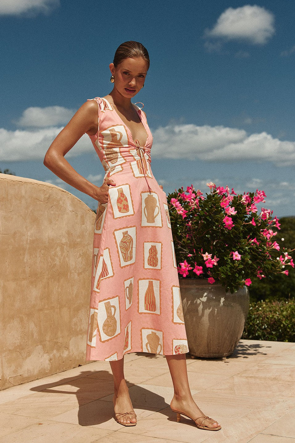 Pink midi dress with a V neckline, side view