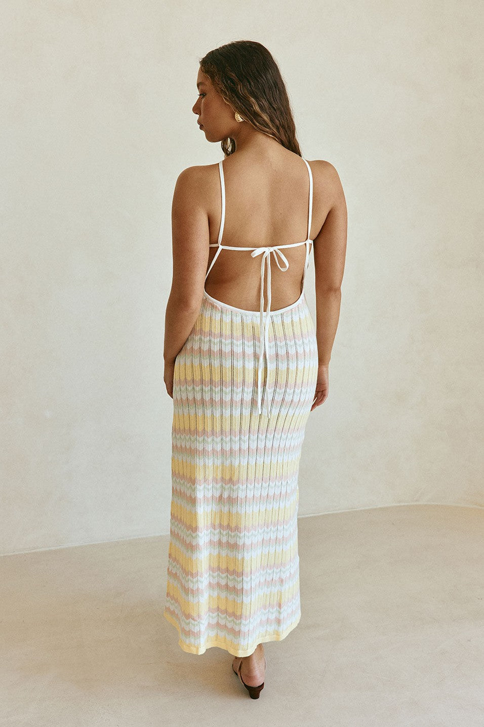 Yellow maxi dress with a halter neckline, styled on model