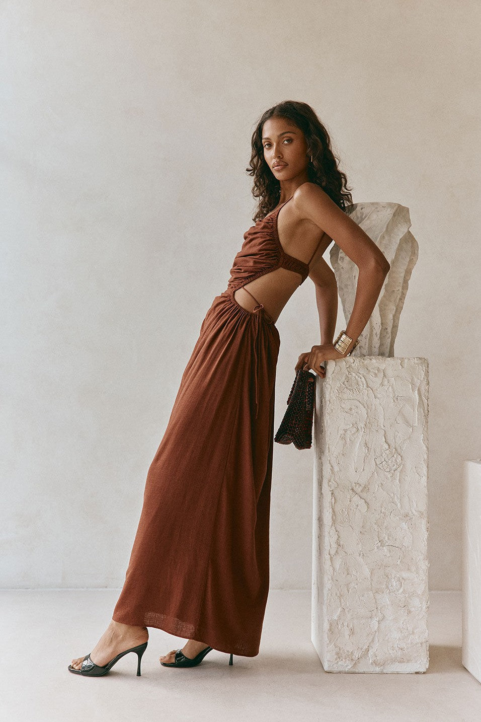 Brown maxi dress with an open back, side view
