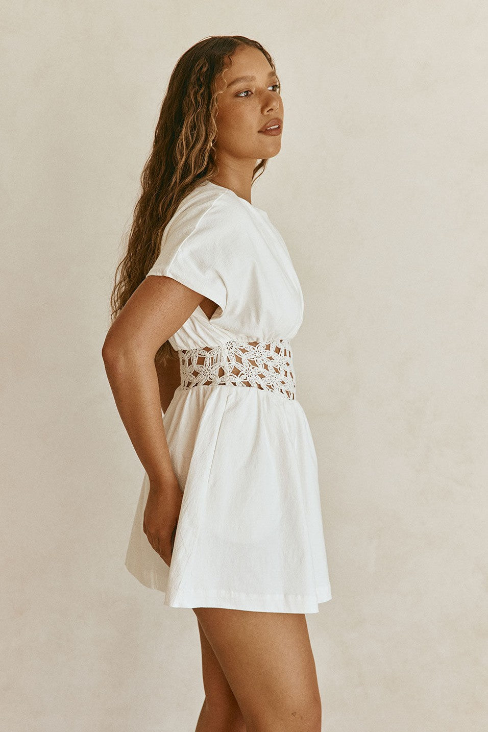 White mini dress with a boat neckline, detail view