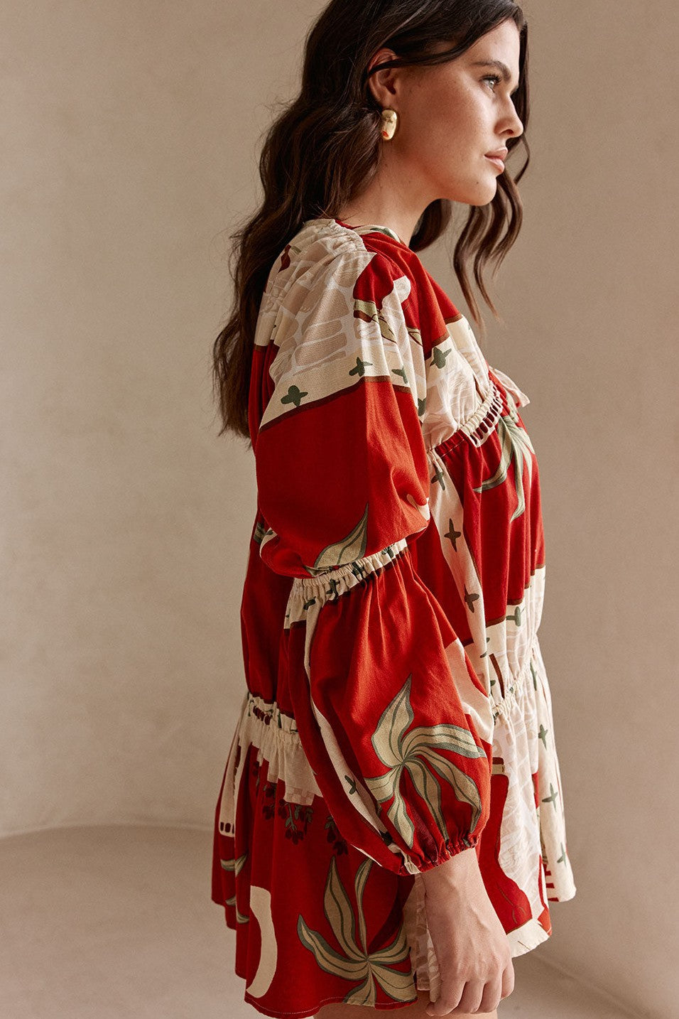 Red mini dress with a V neckline, detail view
