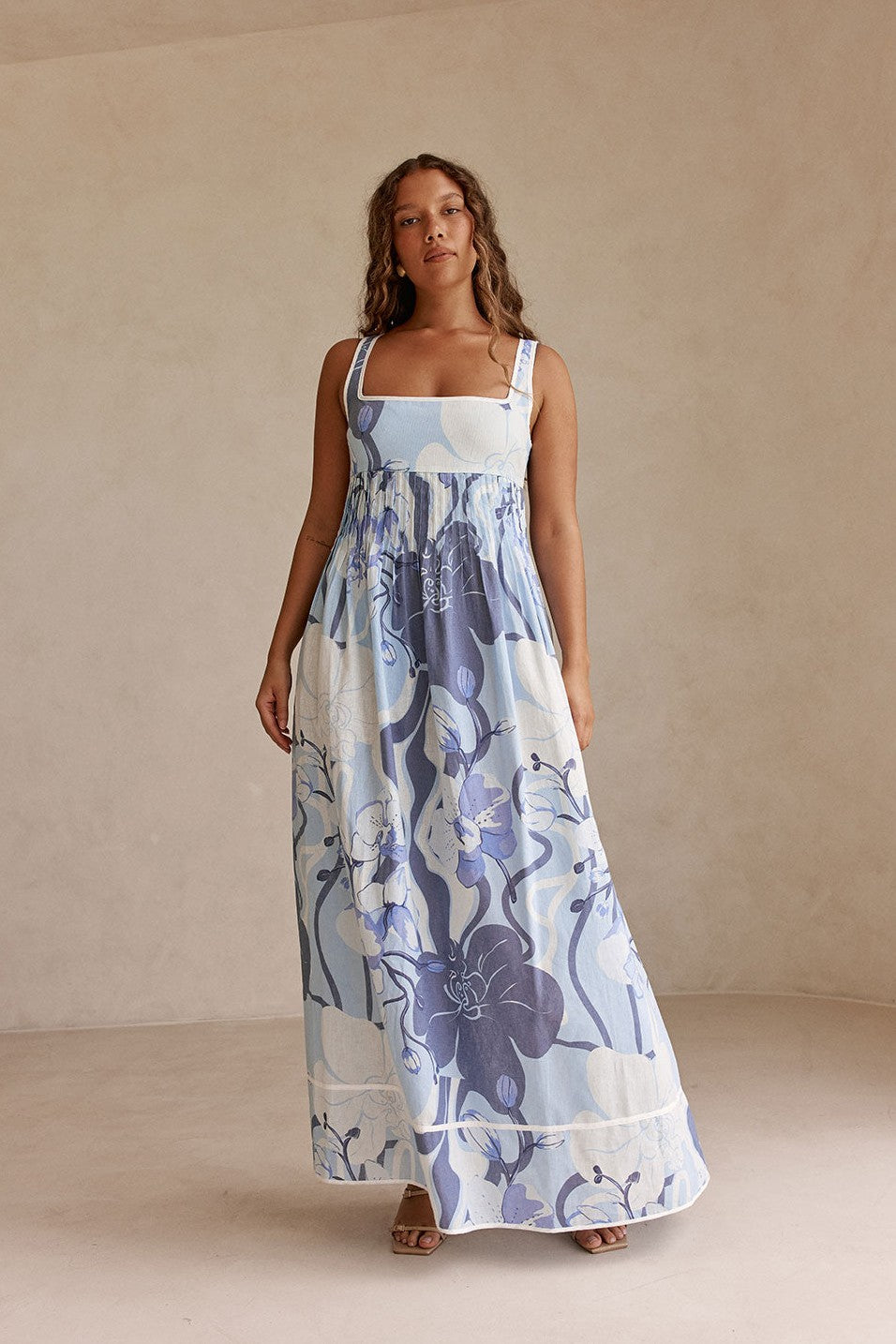 Blue maxi dress with an A-line skirt, side view