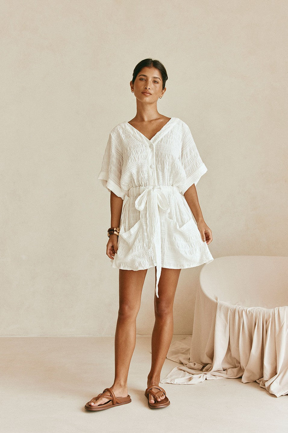 White mini dress with a V neckline, back view