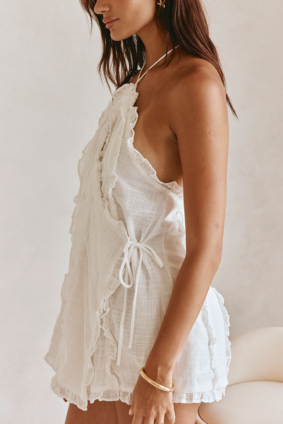 White mini dress with a halter neckline, detail view
