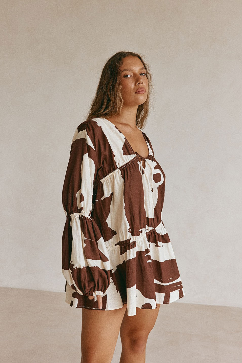 Brown mini dress with a V neckline, back view