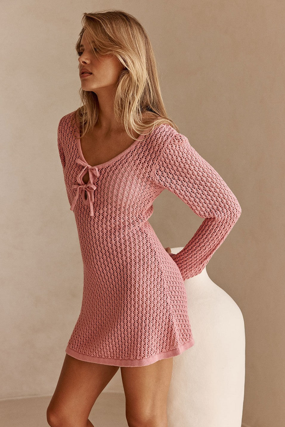 Pink mini dress with a V neckline, side view