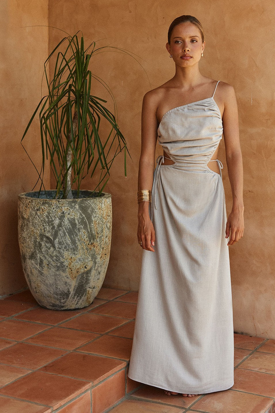 Grey maxi dress with an open back, side view