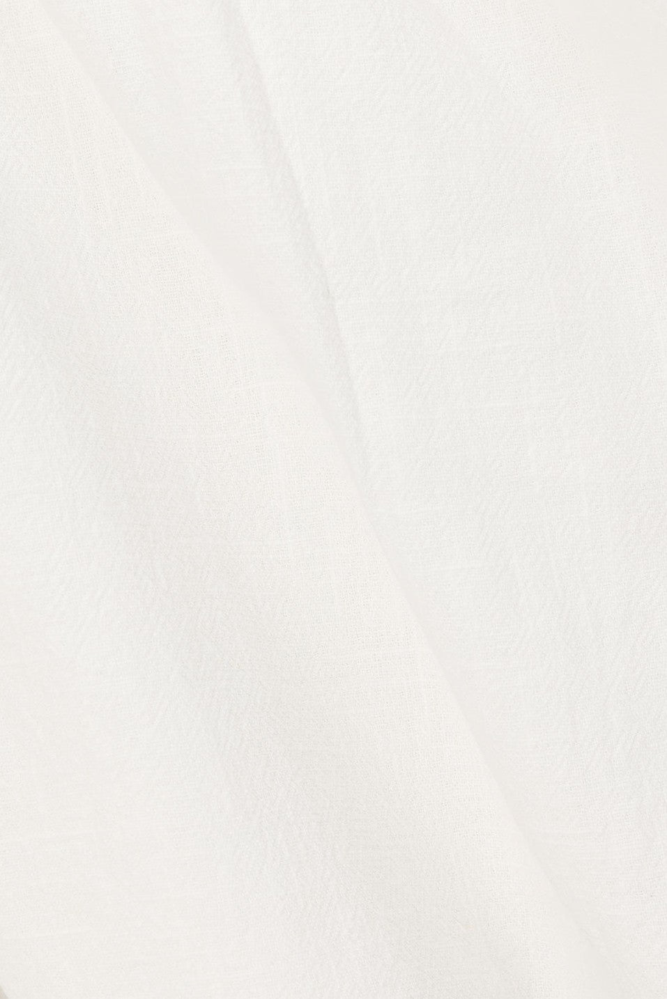 White mini dress with a wrap silhouette, side view