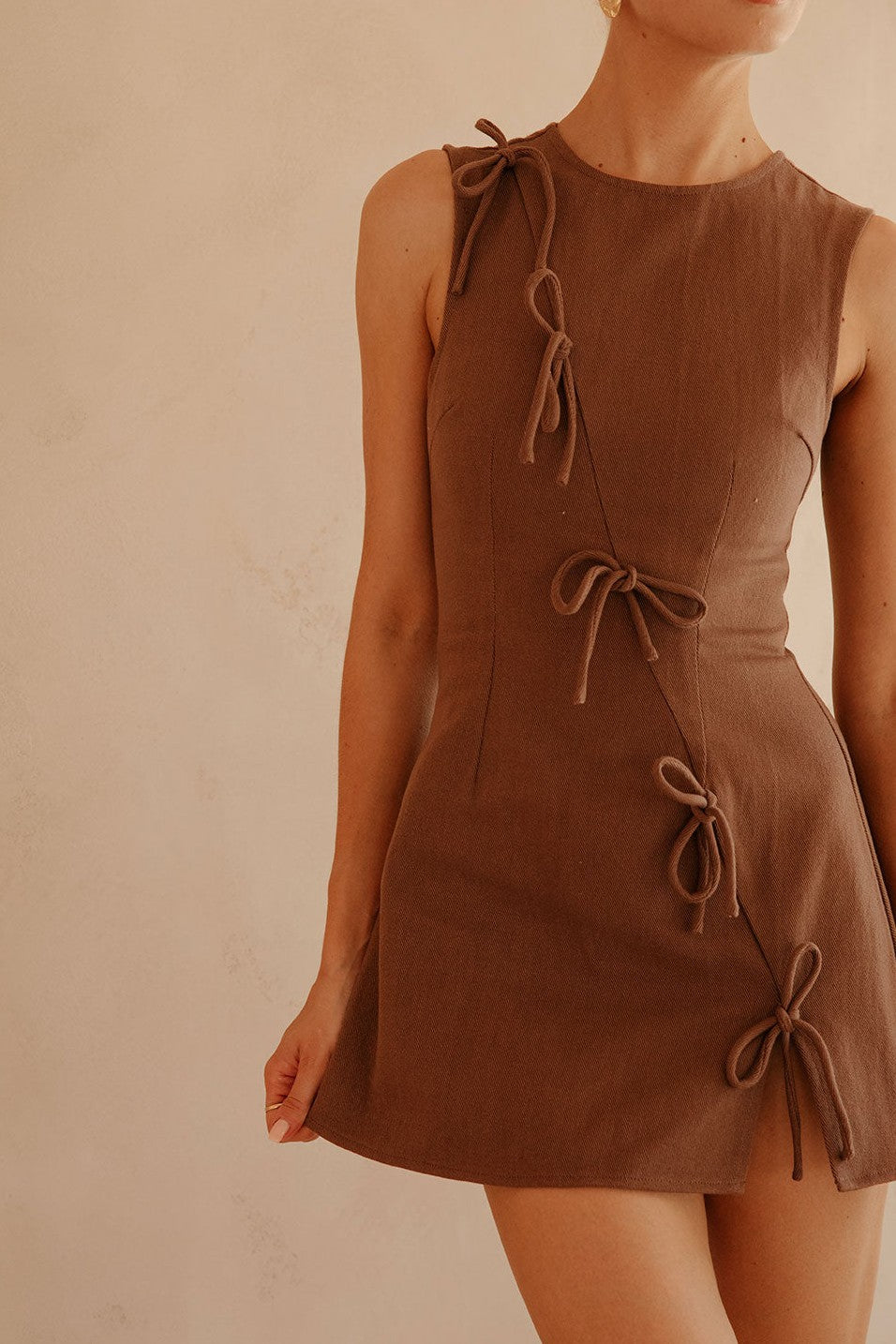 Brown mini dress with an A-line skirt, side view