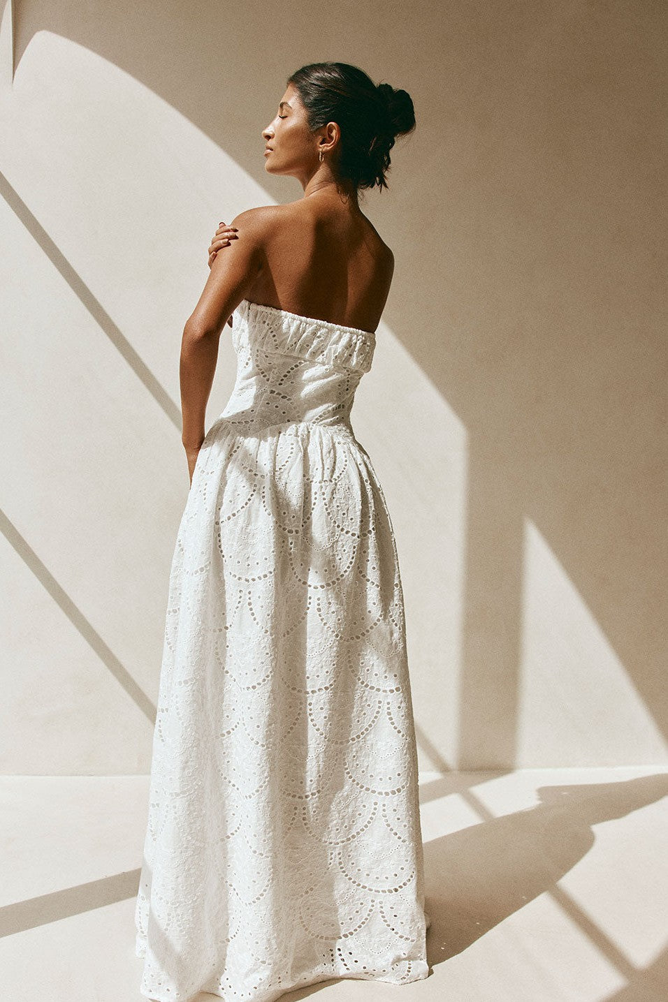 White maxi dress with a strapless neckline, side view