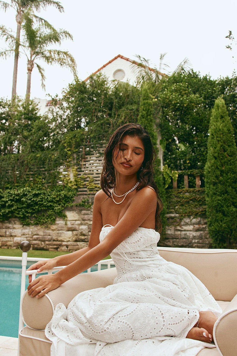 White maxi dress with a strapless neckline, side view
