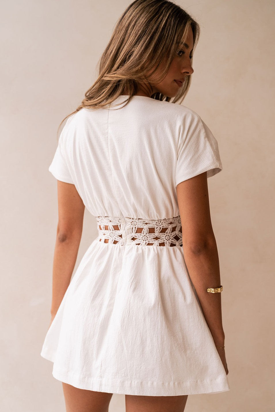 White mini dress with a boat neckline, detail view