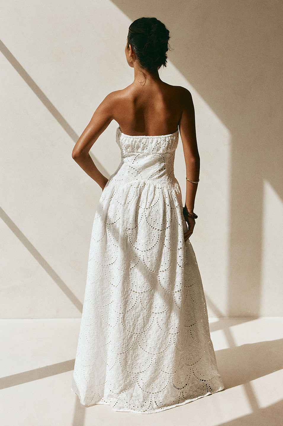 White maxi dress with a strapless neckline, styled on model