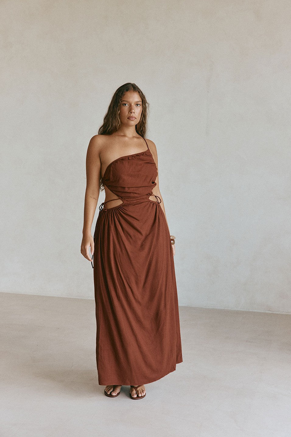 Brown maxi dress with an open back, front view