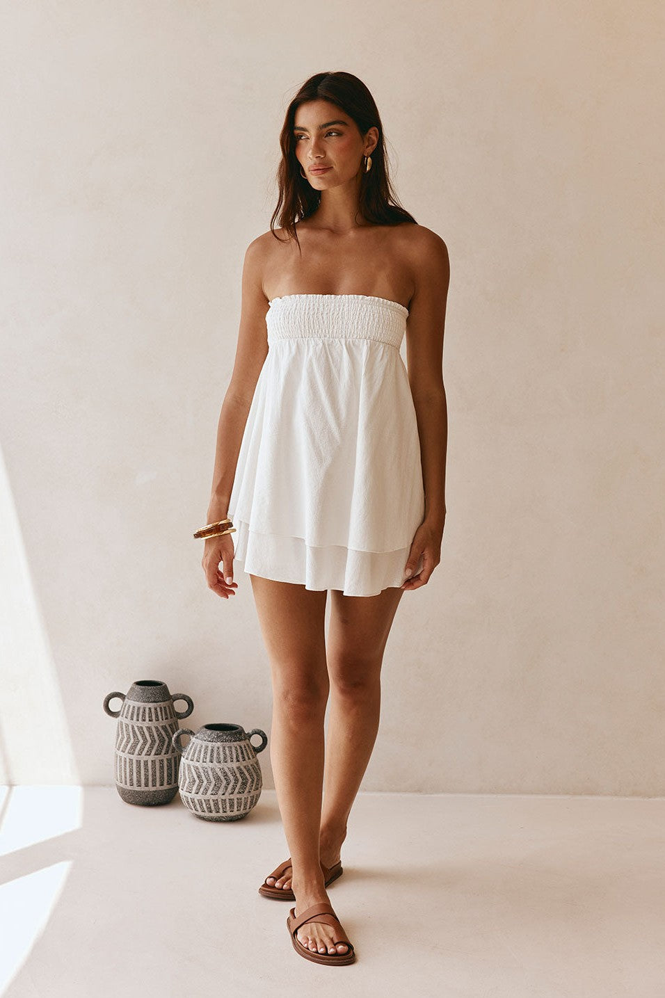 White mini dress with a strapless neckline, side view