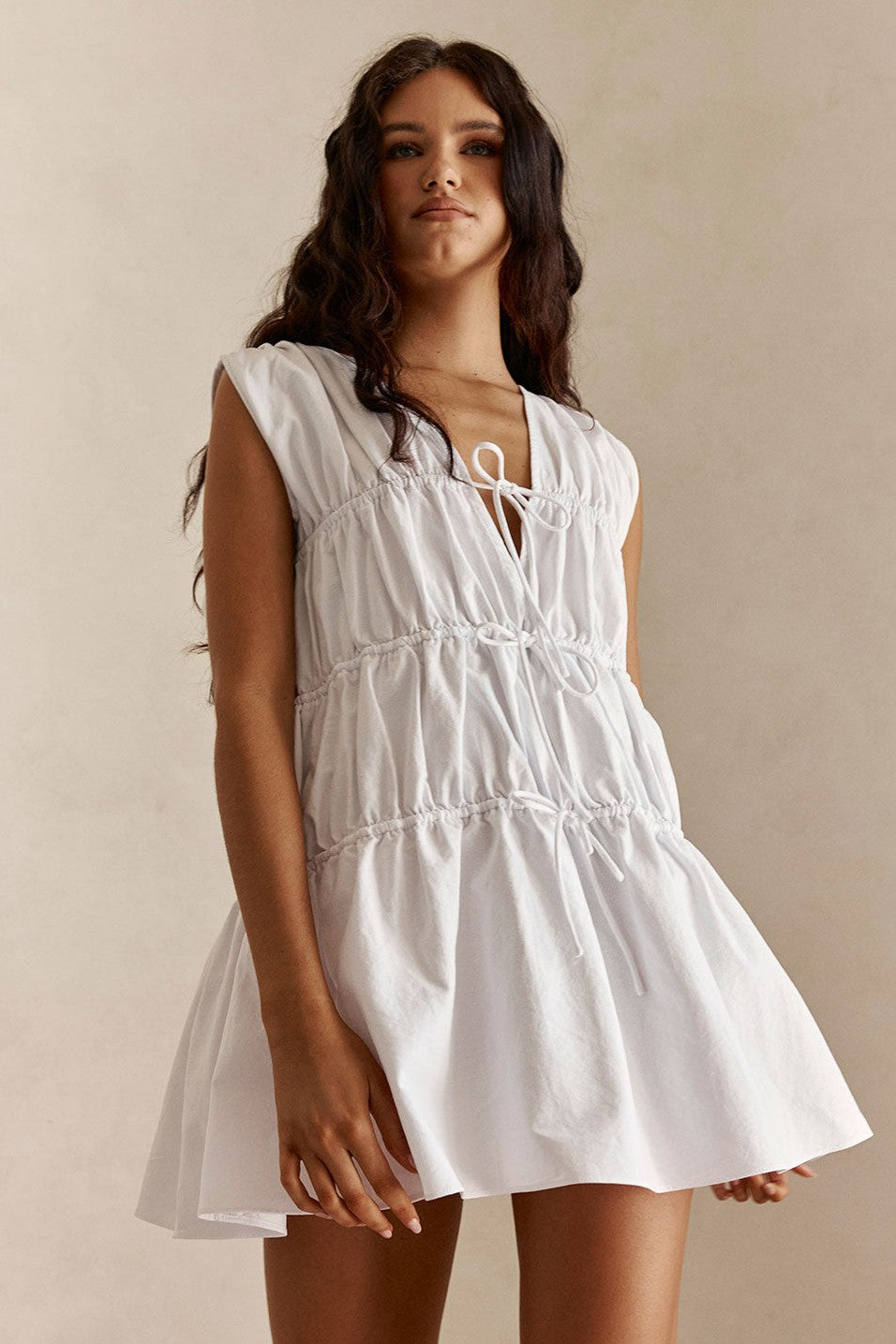White mini dress with a V neckline, front view