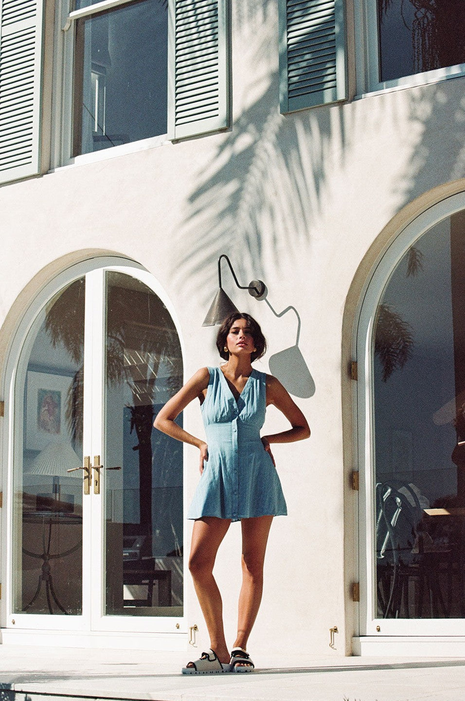 Blue mini dress with a plunging V neckline, back view