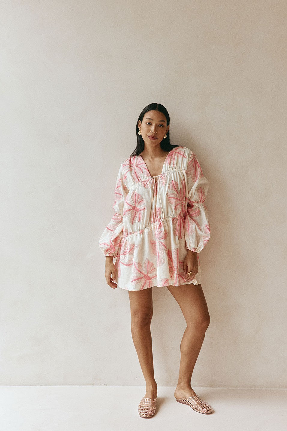 Pink mini dress with a V neckline, detail view