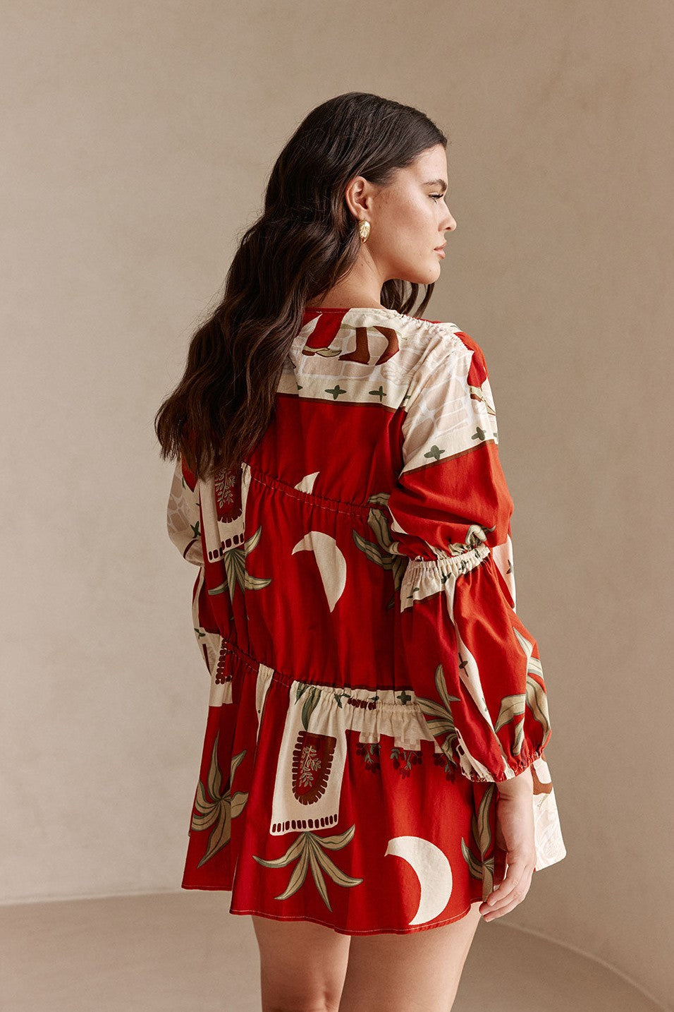 Red mini dress with a V neckline, styled on model