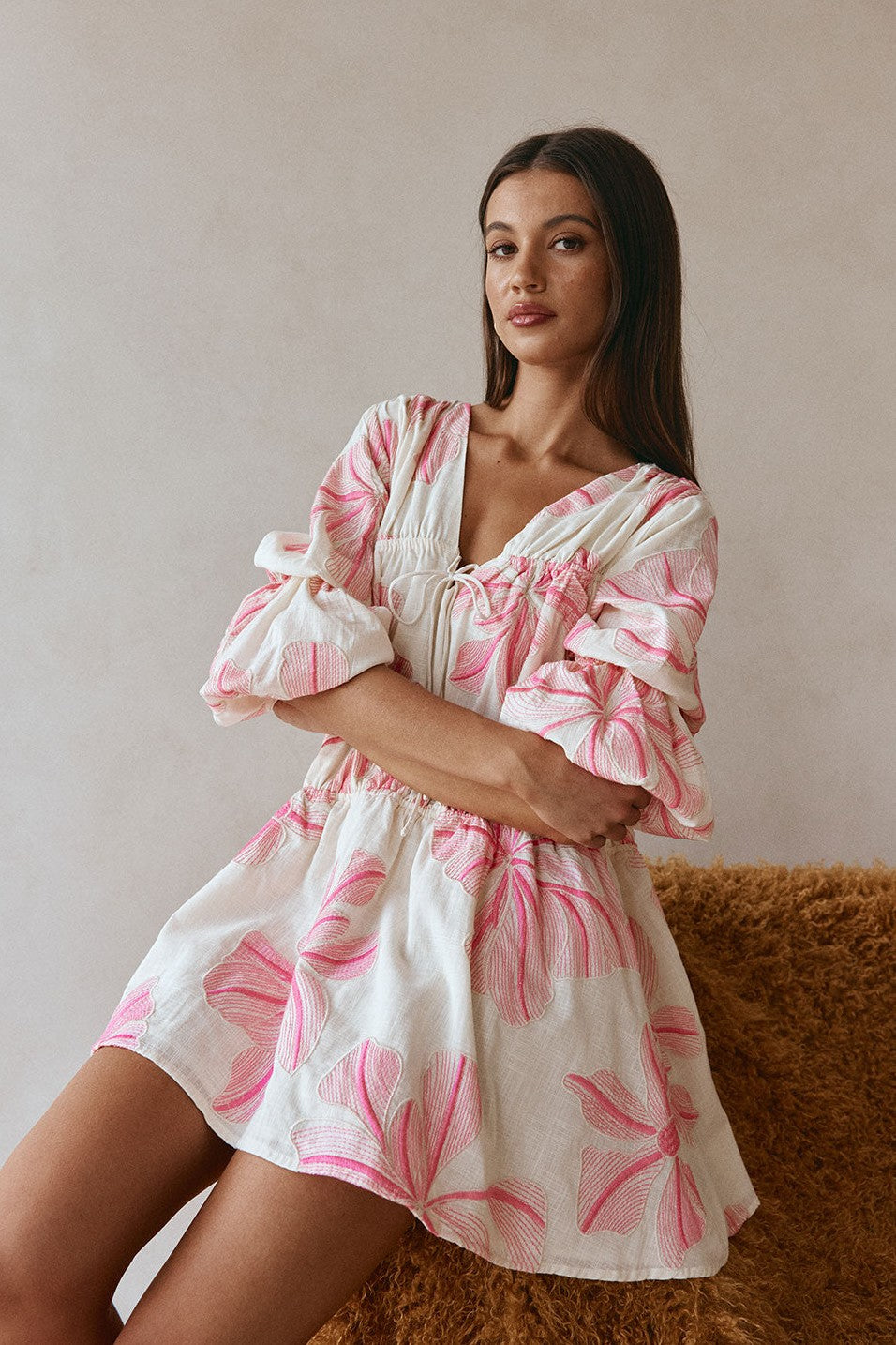 Pink mini dress with a V neckline, side view