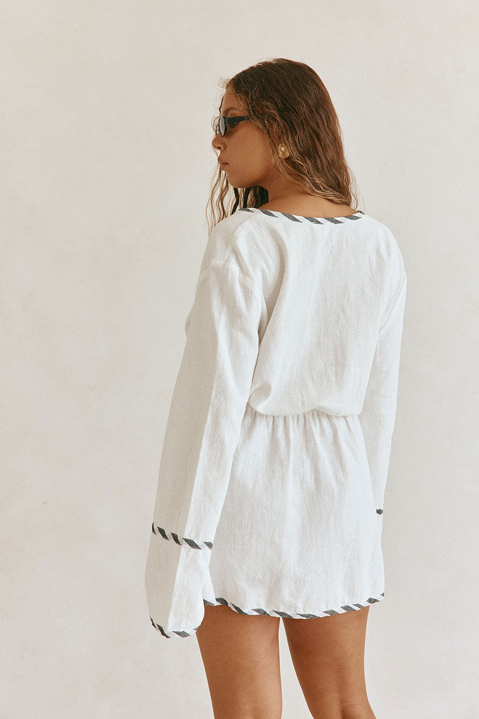 White mini dress with a wrap silhouette, front view