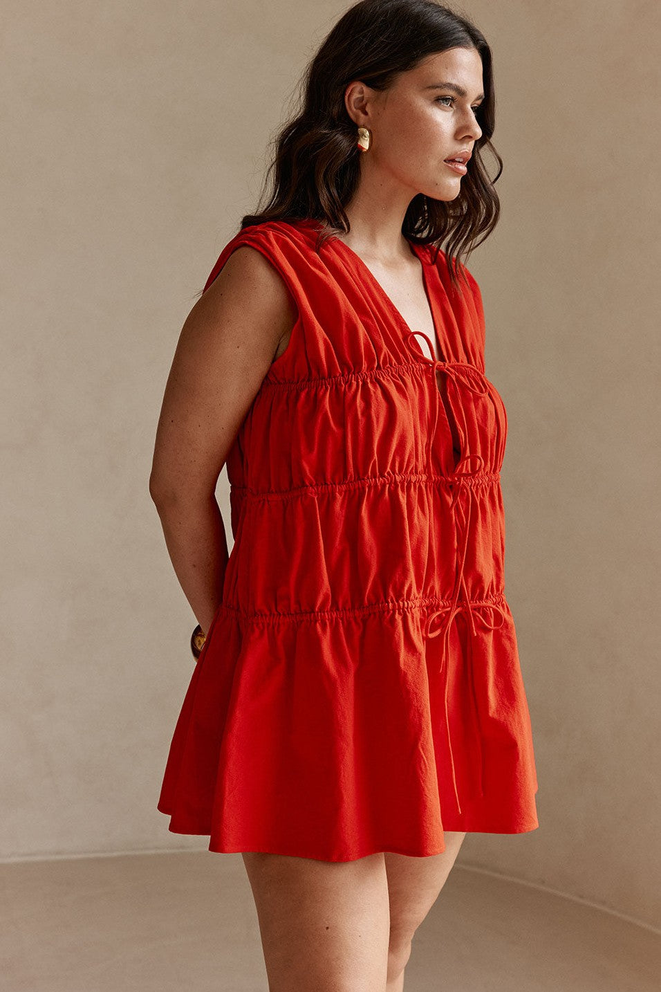 Red mini dress with a V neckline, styled on model