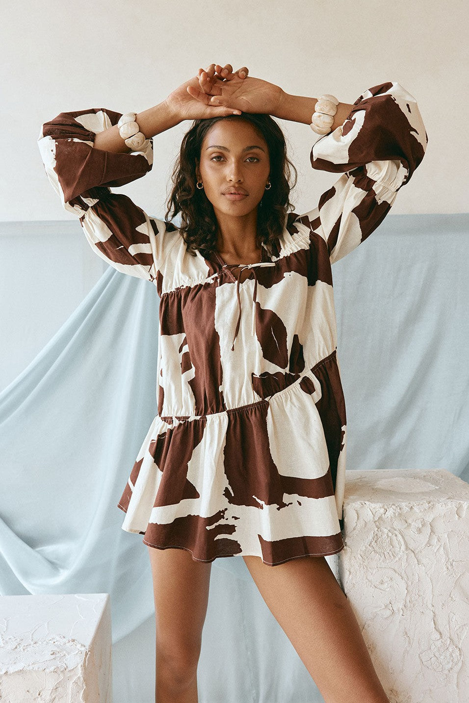 Brown mini dress with a V neckline, side view