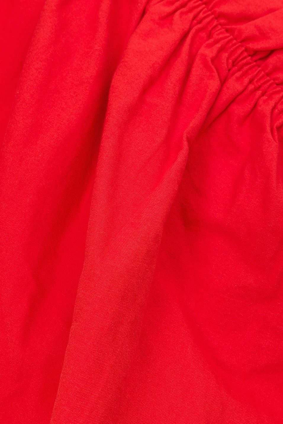Red mini dress with a V neckline, side view