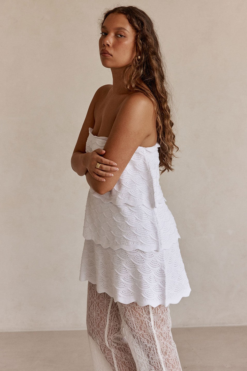 White mini dress with a strapless neckline, side view