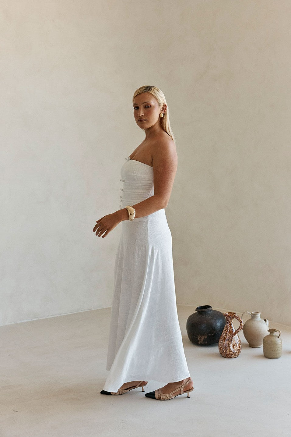 White maxi dress with a strapless neckline, styled on model