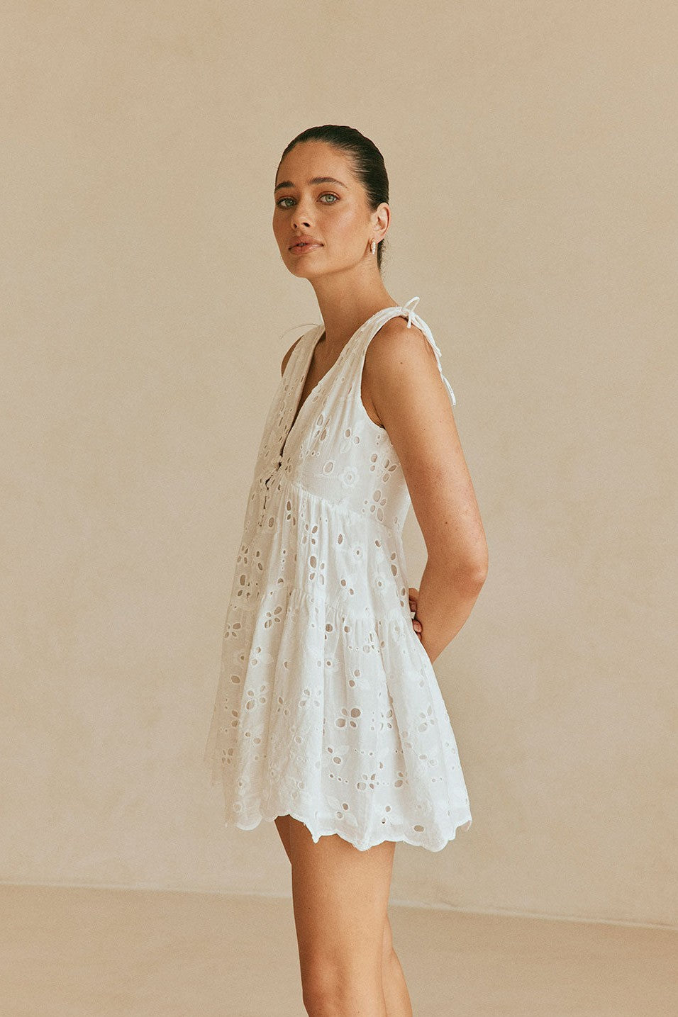 White mini dress with a V neckline, side view