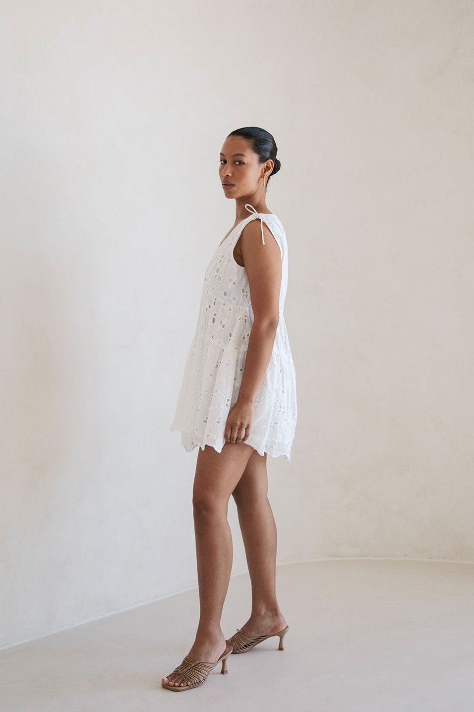 White mini dress with a V neckline, back view
