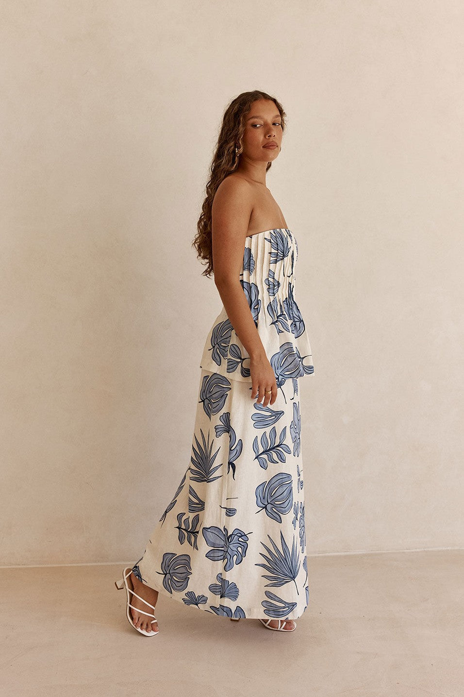 Blue maxi dress with a strapless neckline, styled on model